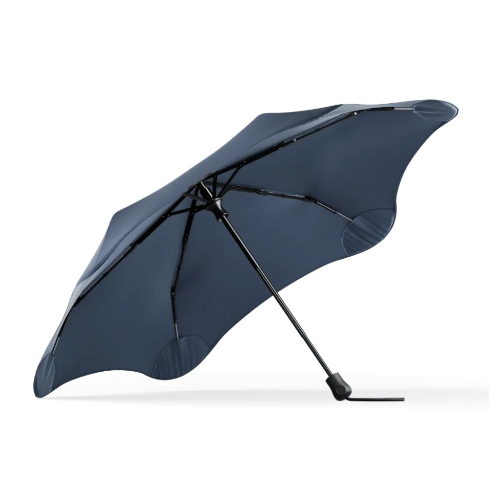 A navy blue compact umbrella with a black handle and ribs, shown open against a clean white background.